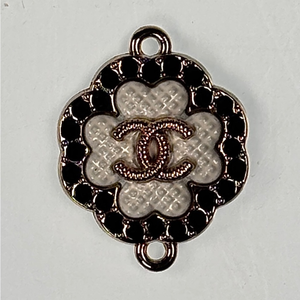 CHANEL Gold and Black crystals charm. Stamped on back